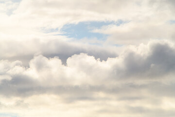 view of white and grey thick cumulus clouds on blue sky.