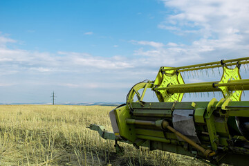 Fragment of a combine harvester on agricultural land. Eco farming concept