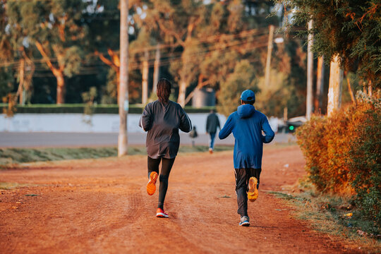 Running training in Kenya. A group of Kenyan runners prepare for a marathon and run on red soil. Marathon running, Track and Field. Simple sports life in Kenya. Motivation for training and exercise.
