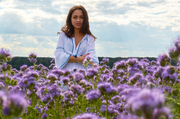 a girl in the national costume of Ukraine in a field of flowers