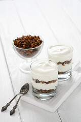 Greek yogurt with granola in glass jar. Parfait