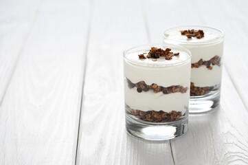 Greek yogurt with granola in glass jar. Parfait