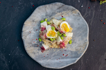 Oatmeal with boiled egg, bacon and green peas. Healthy and tasty breakfast