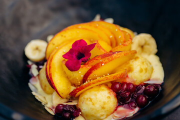 Sweet oatmeal with fried cheese balls, peach and cranberries. Healthy breakfast