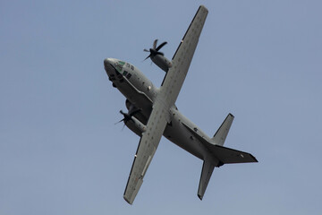 Grey Military Transporter Turboprop Aircraft in steep high angle of attack roll 