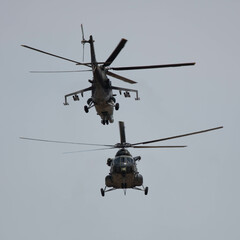 Two Military Helicopters facing each other in flight at close range 