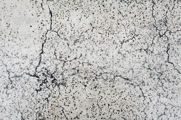 A concrete wall backdrop or texture, with cracks and damages. Old, worn, aged surface, still flat.
