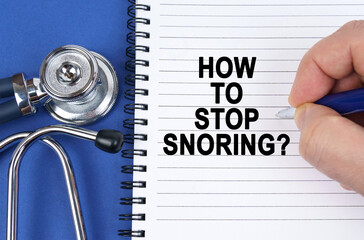 On a blue surface lies a stethoscope and a notebook in which it is written by hand - How to stop snoring - Powered by Adobe