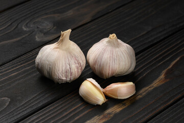 Fresh garlic on a rustic wooden background.