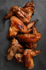 appetizing chicken wings grilled barbecue with spices and vegetables until crisp