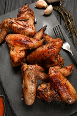 appetizing chicken wings grilled barbecue with spices and vegetables until crisp