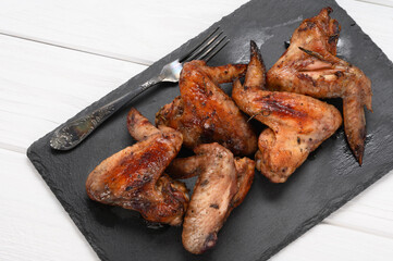 appetizing chicken wings grilled barbecue with spices and vegetables until crisp