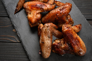 appetizing chicken wings grilled barbecue with spices and vegetables until crisp