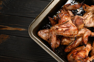 appetizing chicken wings grilled barbecue with spices and vegetables until crisp