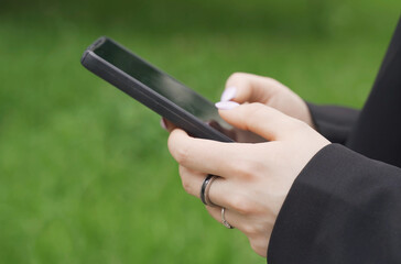 A woman is typing a message on her smartphone.