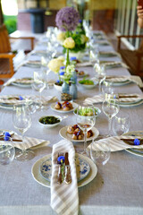 beautiful setting of a large table with snacks and flowers. 