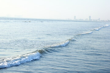 A beautiful picture of seaview wave with buildings karachi sindh. peoples of karachi. - obrazy, fototapety, plakaty