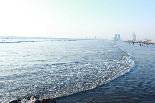 A beautiful picture of seaview wave with buildings karachi sindh. peoples of karachi.