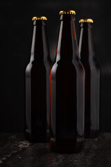 Three bottles of beer on a dark background