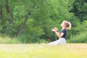 Woman kneeling in field worshipping God
