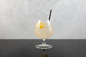 Pomada drink on grey background. Refreshing summer iced cocktail with gin and lemonade. Selective...
