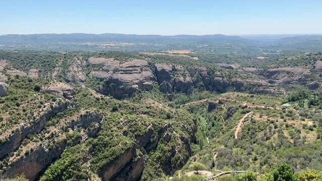 a limestone outcrop, gorge and rock formation from the eocene period seen from Alquezar village in Spain, a former fortress with an active church built atop a limestone outcrop