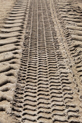 Large tire marks on sand
