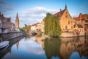 Fototapeta premium Rozenhoedkaai canal reflection at sunrise and blurred clouds, Bruges