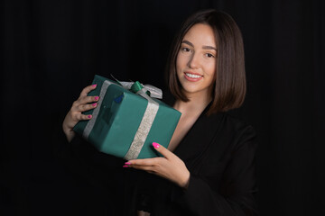 Girl model with gifts Christmas party on black background