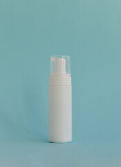 Cosmetics, Moisturizer, Bottle. Blank plastic cosmetics bottle on blue background with copy space
