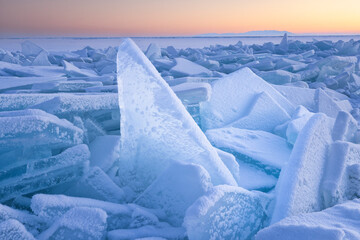 snowed blocks of clear ice ar sunrise