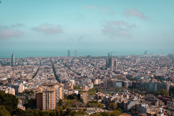 Aerial view of Barcelona city on a sunny day. Residential buildings and streets in the distance