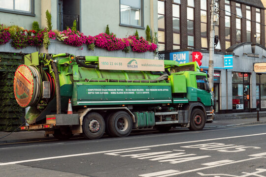 Galway, Ireland - 07.22.2022: Heavy Drain Truck Working On Cleaning Town Old Sewage System. Resolving Urban Problems. Heavy Machinery At Work