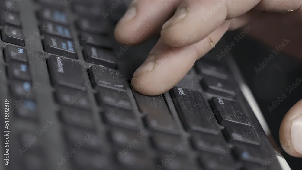 Poster close-up of finger over black laptop keys pressing enter button, computers and technologies concept.