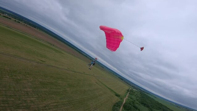 tandem parachute is landing, cloudy weather