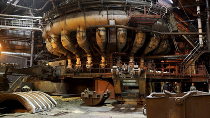 Fototapeta na wymiar Industrial factory equipment with many pipes, heavy industry concept. Enormous machine standing indoor at the metallurgical plant.