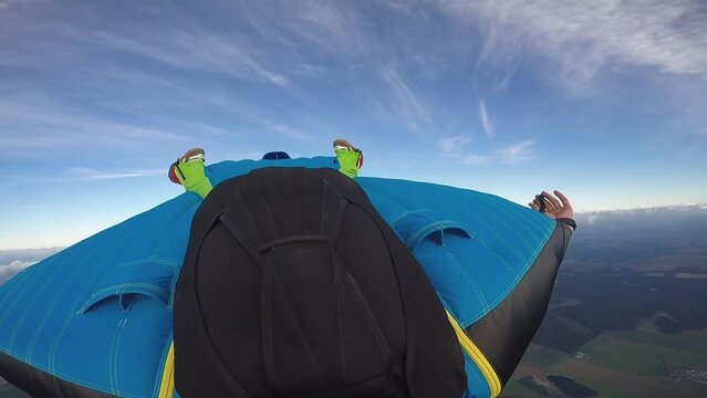 a man jumps out of an airplane with a wingsuit, a guy flies on a wingsuit over the plain