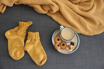 Cozy hygge home style handknitted socks fresh coffee yellow warm blanket