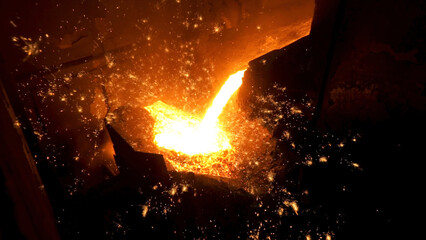 Pouring of liquid metal in open hearth workshop of the metallurgical plant. Stock footage. Smelting...
