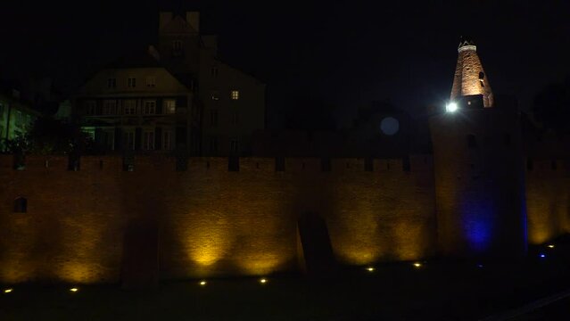 Brick wall in the old town of Warsaw. Night, lights. Poland. 4K.