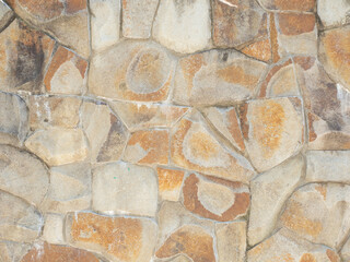 Textured sandstone masonry wall. Wall cladding with coarse decorative stone. Not a seamless texture.