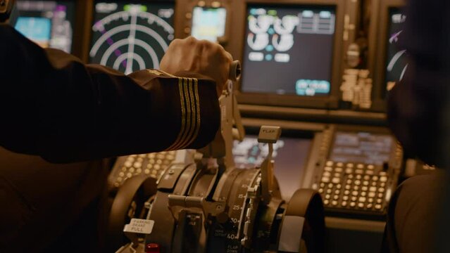 Aircraft captain in cockpit command taking off with airplane, throttling power engine lever to navigate radar compass. Airline service to fly plane with dashboard and control panel. Close up.