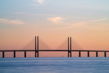 The Oresund Bridge is a combined motorway and railway bridge between Sweden and Denmark (Malmo and Copenhagen). Long exposure. Selective focus.