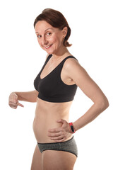 A beautiful woman in early pregnancy shows off her tummy. Happy future mom