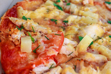 Pizza with pineapple, chicken, tomatoes and cheese