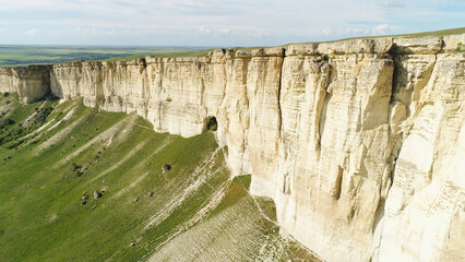 Stunning landscape of White Rock in Crimea with bright green meadow at the foot. Shot. Aerial for...
