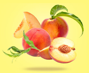 Flying ripe peaches on yellow background