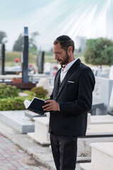 Bearded Jew in black kippah reading a Hebrew Bible, praying, selective focus. Prayer in jewish...