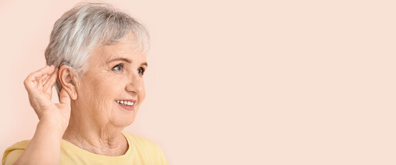 Senior woman with hearing aid on color background. Banner for design