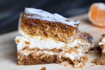 a piece of honey cake with vanilla cream and citrus tangerines